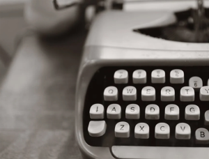 A typewriter on a desk.