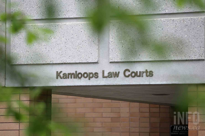 A photo of a brick building with signage reading "Kamloops Law Courts."