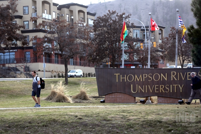 A student walks passed a Thompson Rivers University entrance sign.
