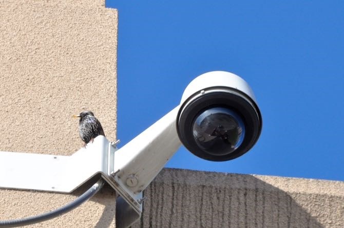 A CCTV camera on the side of a building.