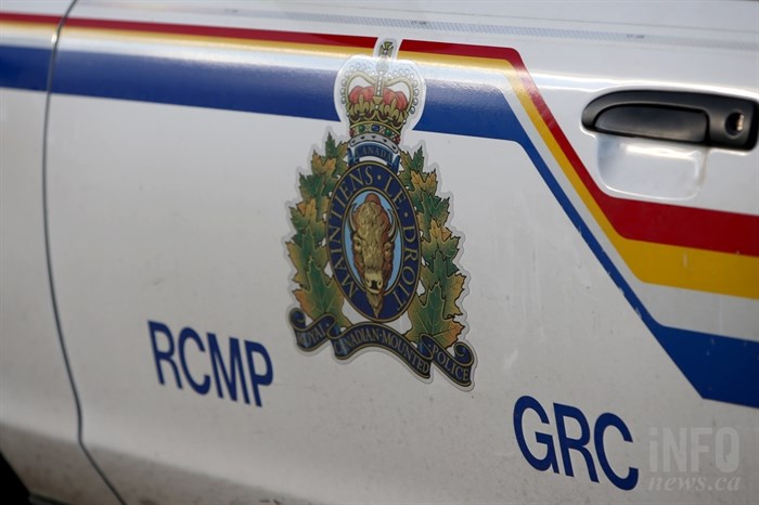 A close-up of the side of an RCMP squad car door focused on the RCMP logo.