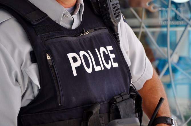 An RCMP officer with a vest on.