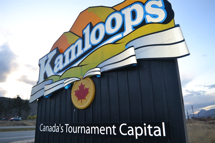 A roadside entrance sign depicts the City of Kamloops logo