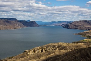 Aerial image showing a lake surrounded by arid mountains.