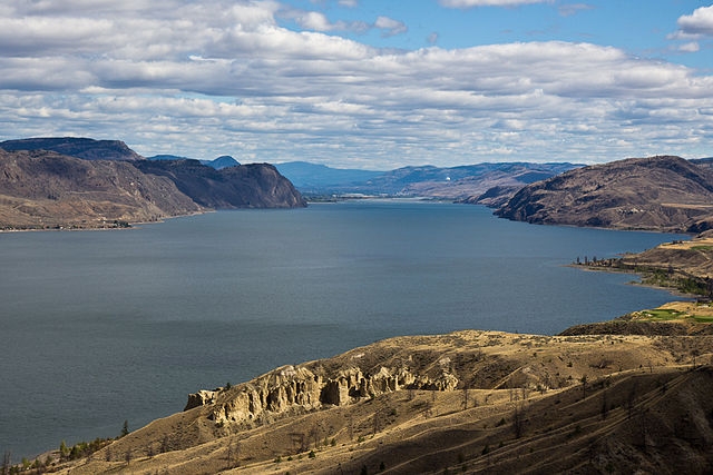 Aerial image showing a lake surrounded by arid mountains.