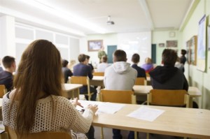 Students sit in a classroom.