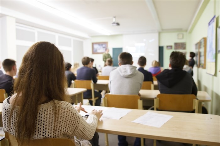 Students sit in a classroom.