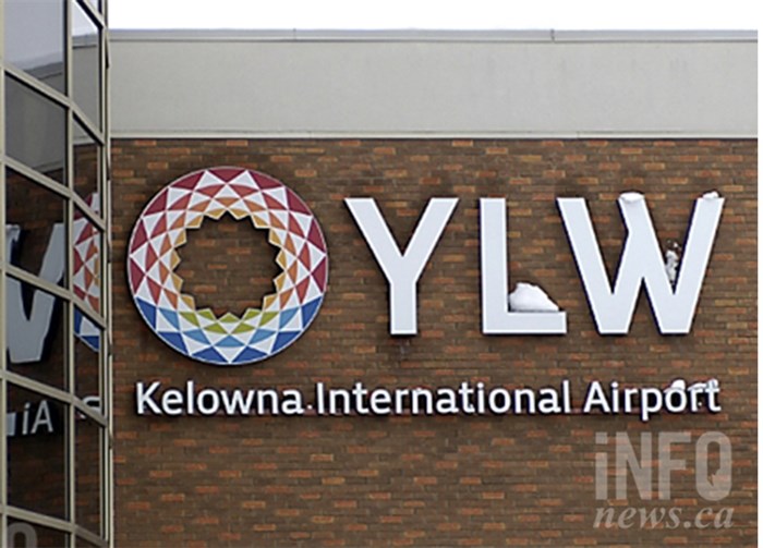 A sign on the side of a building reads YLW Kelowna International Airport.
