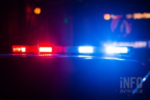 An RCMP vehicle at night with emergency lights on.