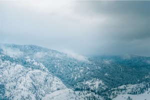 Snow in forested mountains.