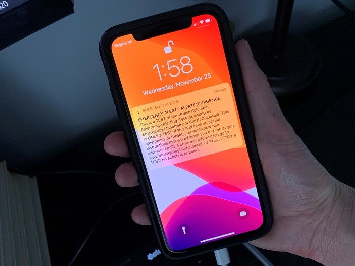 Canada's public alert system faces uncertain future | iNFOnews.ca A person holds a cellphone with an emergency alert on the screen.