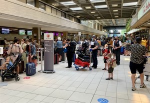 A bunch of people waiting in line at Kelowna International Airport.