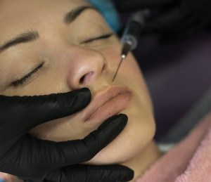 A patient receives a lip injection.