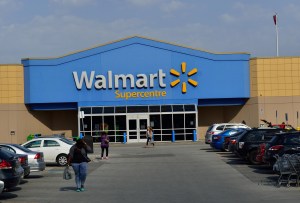 a peson walks in the parking lot of a walkmart storestore