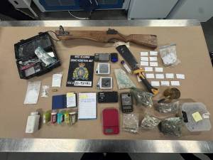 A collection of weapons, ammunition and drugs.