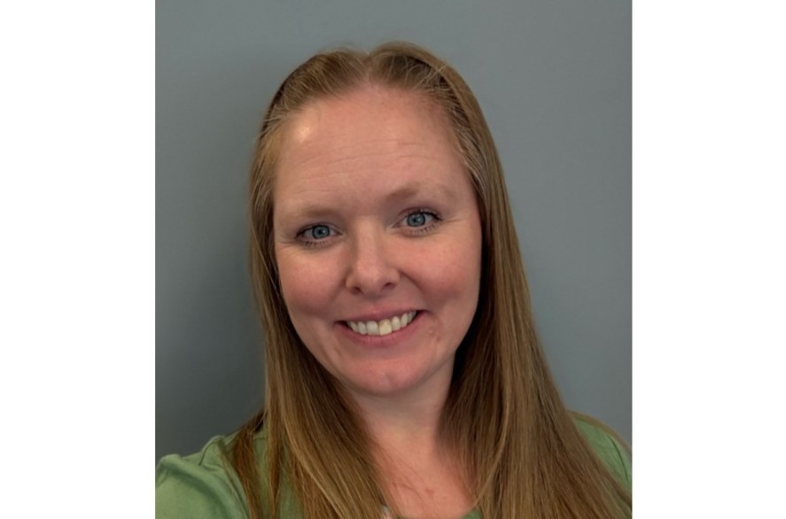 The head shot of a smiling woman is pictured.