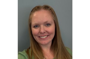 The head shot of a smiling woman is pictured.