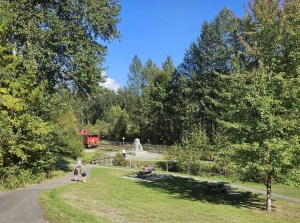 A big park has a monument in the distance.