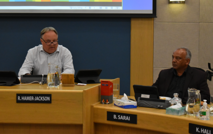 Two local politicians in a council meeting.