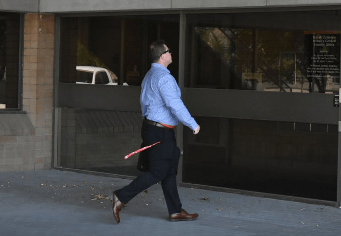 Joel Eric Carlson walking into a courthouse.