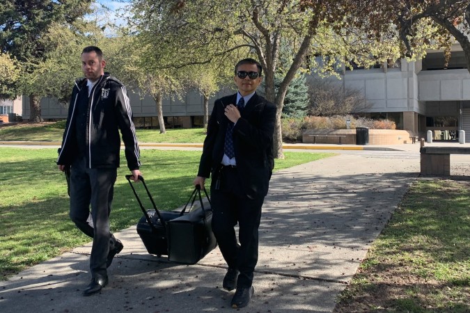 Two men exiting a courthouse.