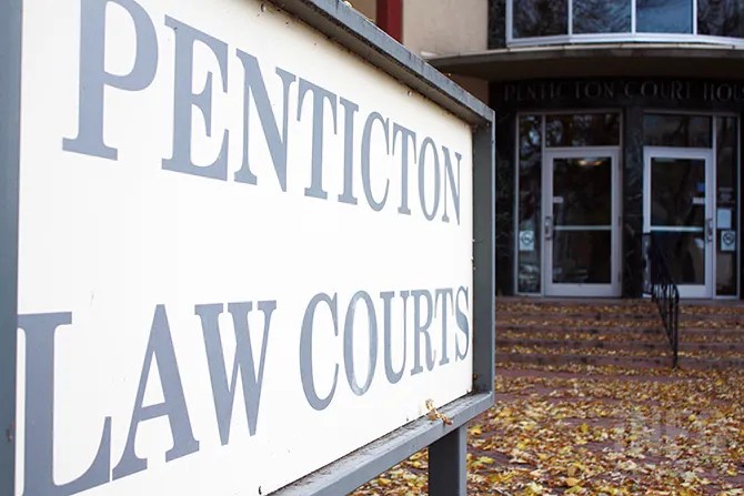 A sign that reads Penticton Law Courts outside the doors of courthouse.