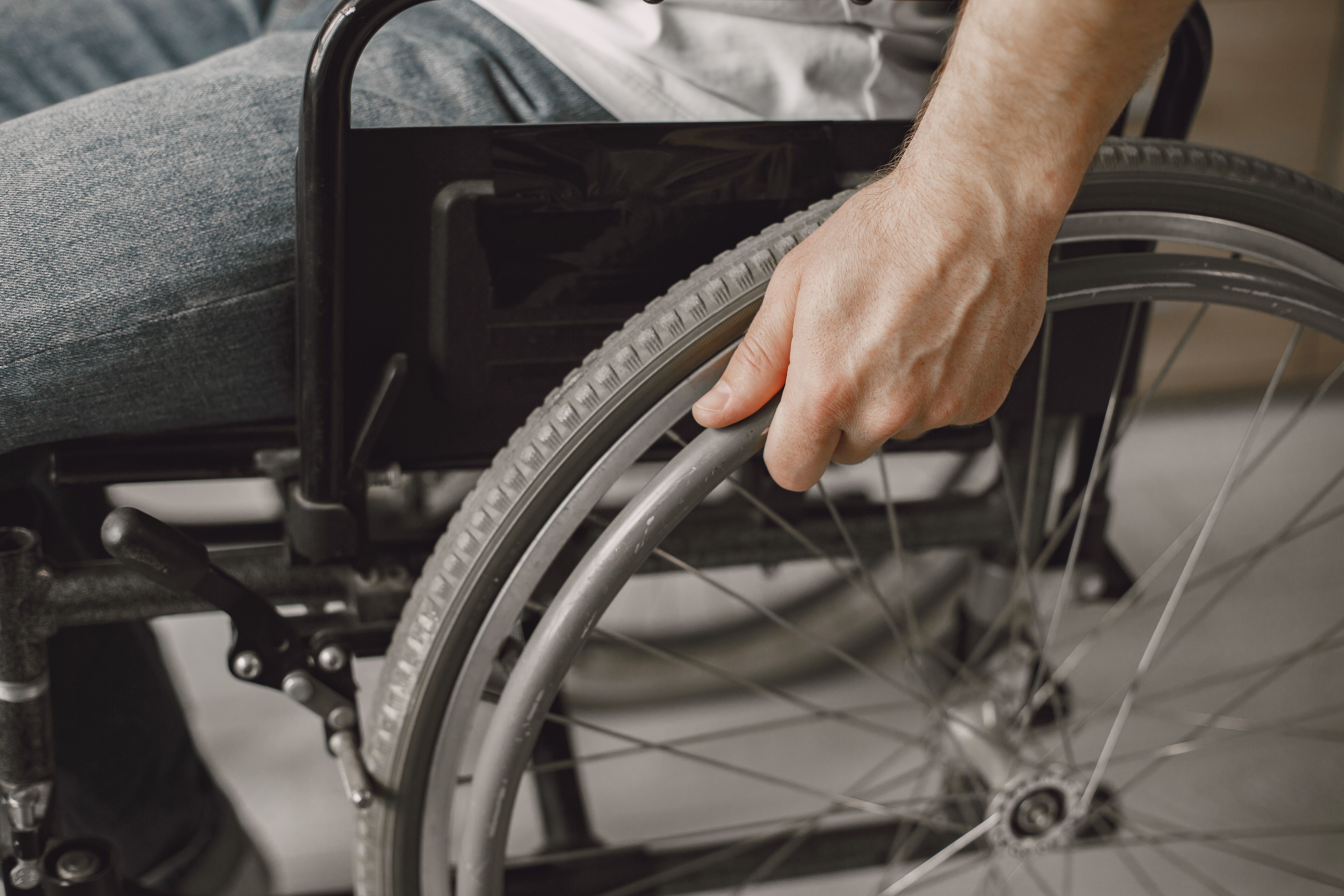 A person sits in a wheelchair.