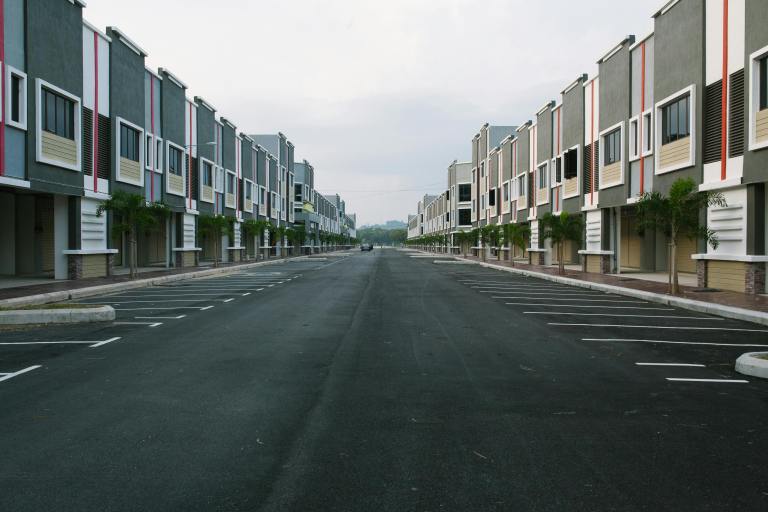 A parking lot surrounded by townhomes.