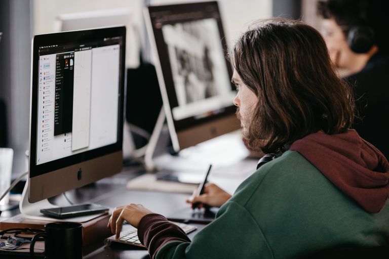 People at work on computers in an office.