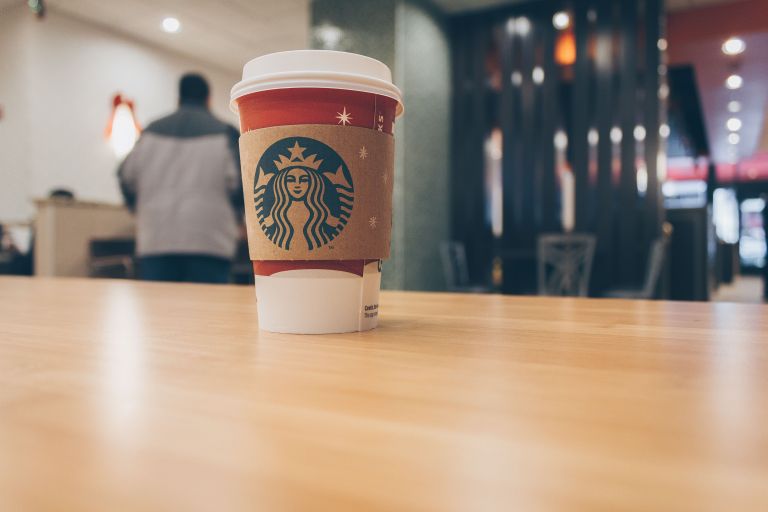A Starbucks coffee on an empty counter.