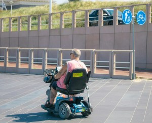 A man drives a mobility scooter.