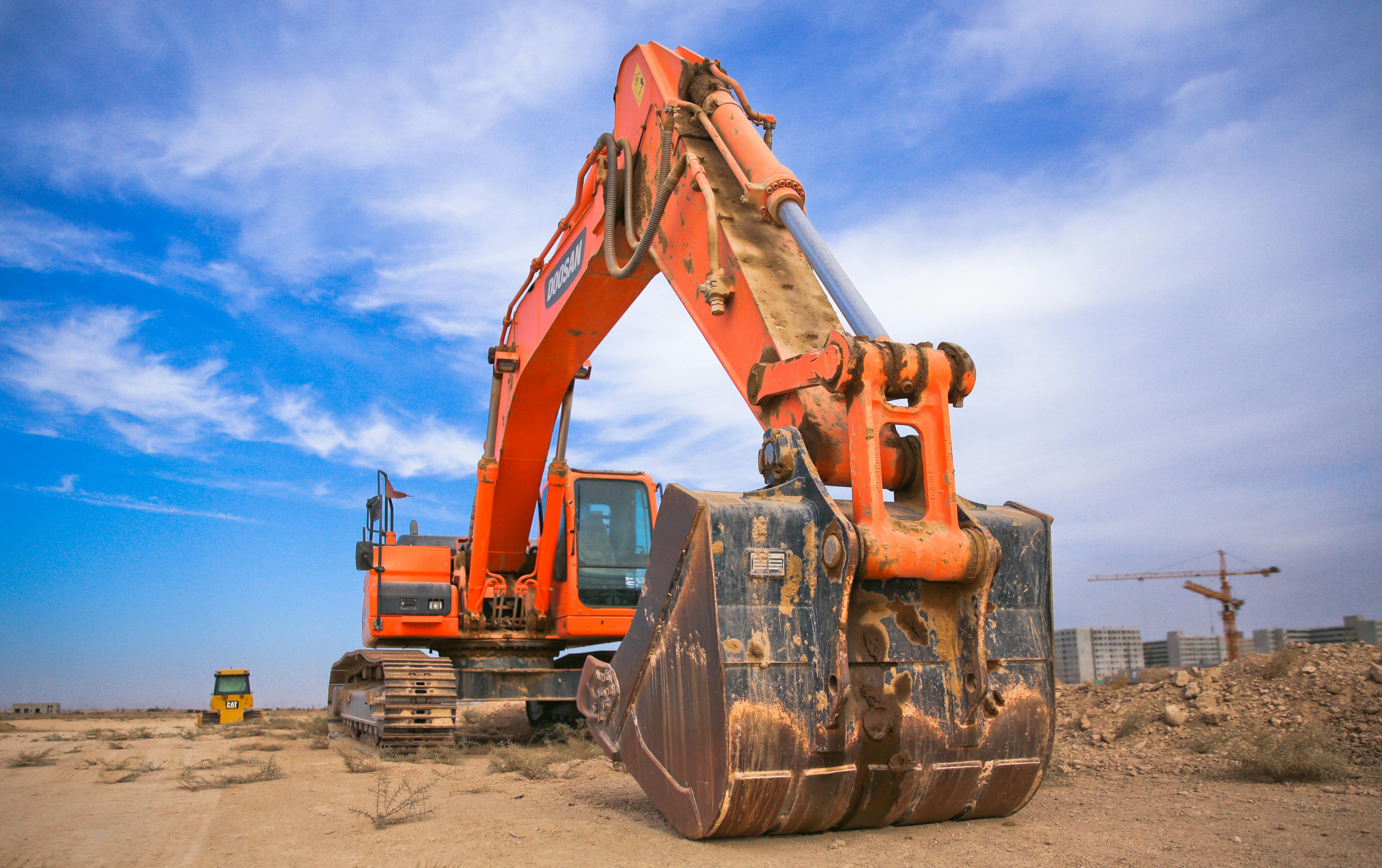 A large excavator with bucket on a construction site.