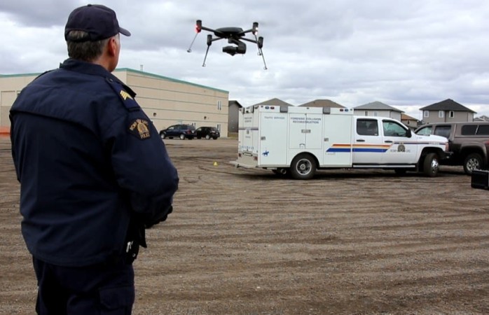 A police officer pilots a low-flying drone.