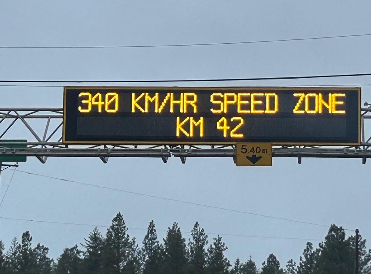 A digital highway sign shows a speed zone is 340 kilometres per hour.