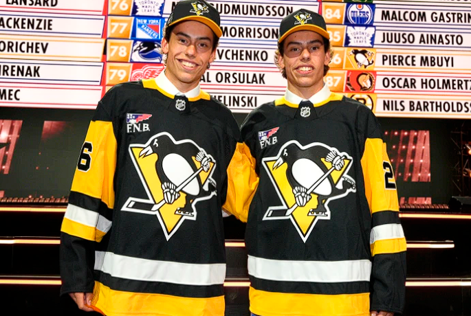 Two young men wearing NHL jerseys pose for a photo.