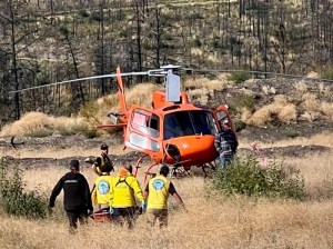 Rescue team walking toward search and rescue helicopter.